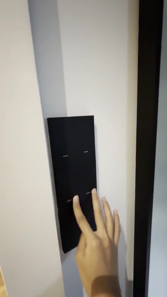 A hand operating a wall switch