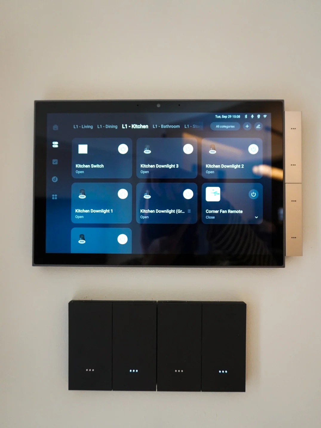 Wall-mounted smart control panel paired with a black switch in a landed home
